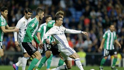 Real Madrid’s Cristiano Ronaldo, right, vies for the ball with Real Betis defenders. Francisco Seco / AP Photo