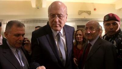 The resignation of Nijab Mikati, centre, as prime minister may be an attempt to boost his credentials among his fellow Sunnis ahead of elections. Hussein Malla / AP Photo