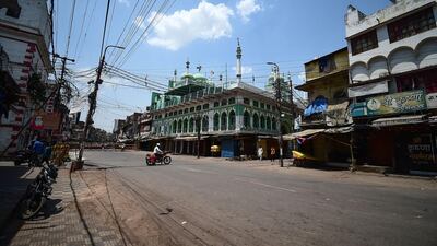 A man crosses an empty road during a weekend lockdown imposed by the government as a preventive measure against the Covid-19 coronavirus, in Allahabad. AFP