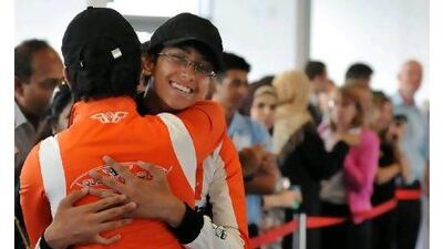 ABU DHABI, UNITED ARAB EMIRATES - April 26, 2011 - Various schools competed in the F1 in Schools competition for a spot at the F1 in Schools World Championship in Malaysia. Ahmad Yousuf, 16, and his teammate Ashik Shajahan, 16 (back to camera) celebrate a fast speed for their car during one of the Blackbird team's track run. (DELORES JOHNSON / The National )