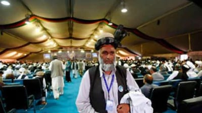 A delegate leaves the peace jirga tent after hearing blasts from a rocket attack in Kabul.
