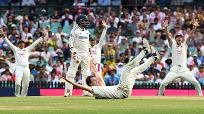 Australia’s bowler Pat Cummins falls on the ground while appealing. AFP