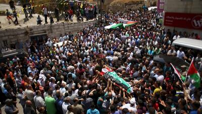 Mourners carry the body of Palestinian Abdullah Ghanayem during his funeral in the village of Qafr Malik near Ramallah on June 14. An Israeli army jeep struck and killed Ghanayem in the occupied West Bank on Sunday. REUTERS