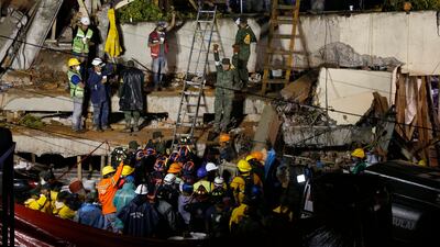 Rescue personnel work on the rescue of a trapped child at the collapsed Enrique Rebsamen primary schoool. Marco Ugarte / AP Photo