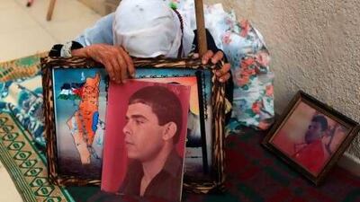 The mother of Palestinian Fares Baroud, who has been held in an Israeli prison for 22 years, cries as she holds his picture after hearing news on the possible release of her son at her house in Shati refugee camp in Gaza City.