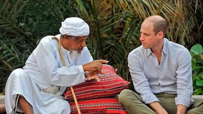 Prince William listens to an elder as he meets with locals in the village of Wadi Arbaeen. AFP