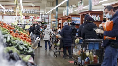 Respecting social distancing, people line up to check out at Greenland Market on the first day of Ramadan in Dearborn Heights. Getty Images via AFP