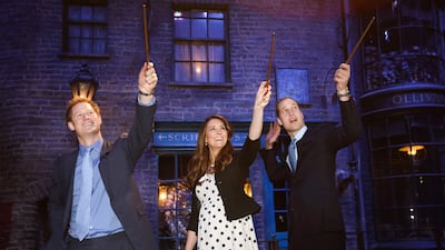 Prince Harry, Catherine and Prince William on the set of Diagon Alley from the Harry Potter films during the opening of the Warner Bros Studios in Leavesden, in April 2013
