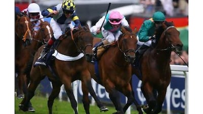 Mac Love, left with jockey in blue and yellow, winning at England's Epsom course. Jamie McDonald / Getty Images