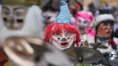 Masked Guggen music bands (brass and percussion carnival bands) parade through the streets at the beginning of the Lucerne Carnival in Lucerne, Switzerland. Urs Flueeler / EPA