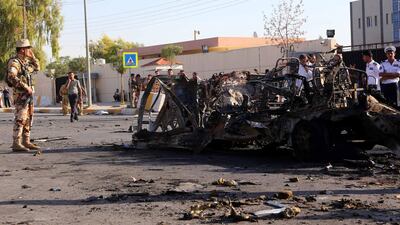 Iraqi Kurdish security forces gather at the site of a car bomb explosion in Erbil on September 29, 2013. Safin Hamed / AFP