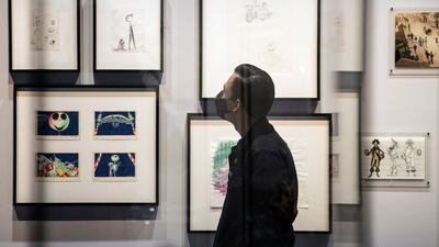 A visitor looks at drawings of 'Nightmare Before Christmas' characters. EPA