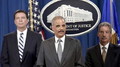 Attorney general Eric Holder, centre, FBI director James Comey, left, and deputy attorney general James Cole announces the deal between the US government and BNP Paribas. Susan Walsh / AP Photo