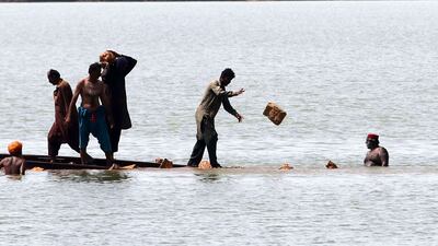Pakistani railway workers repair the track in flooded areas in Sehwan, Sindh Province. EPA