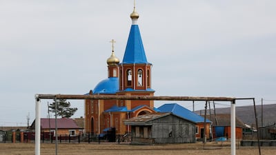 A goalpost stands in front of an Orthodox church in the Siberian village of Tyulkovo in Krasnoyarsk. Ilya Naymushin / Reuters