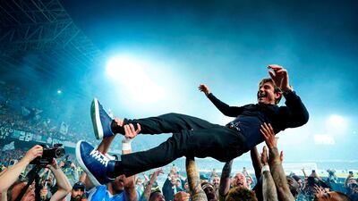 Napoli coach Antonio Conte is thrown in the air by his players as they celebrate winning Serie A. Reuters