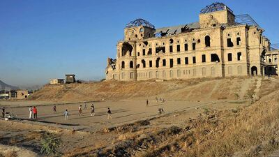 Children play soccer in front of the ruined Darul Aman Palace on the outskirts of Kabul, Afghanistan. The shattered shell of the palace stands in mute testimony to the brutality and callousness of Afghanistan's history of conflict. Noorullah Shirzada / AFP