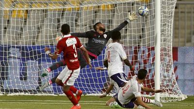 Al Ahly's Moamen Zakaria shoots and scores one of his two goals against Zamalek in the Egyptian Premier League on Tuesday in Alexandria. Amr Abdallah Dalsh / Reuters