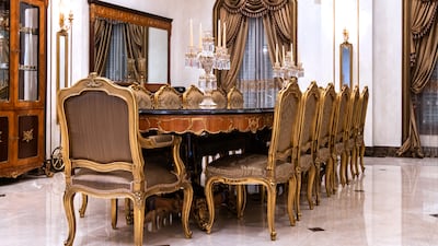 The hand-carved dining table is infused with copper.