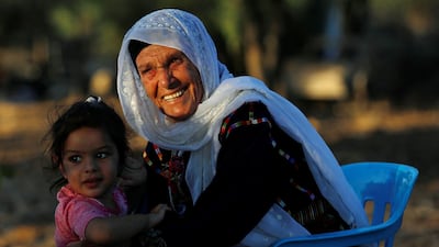 Muftia, the grandmother of US congresswoman Rashida Tlaib, is seen with her granddaughter outside her house in the village of Beit Ur Al Fauqa in the Israeli-occupied West Bank. Reuters