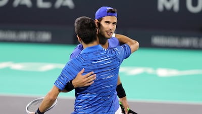 Novak Djokovic and Karen Khachanov embrace at the end of the match.