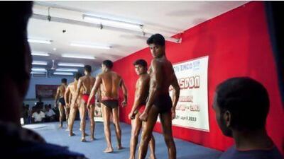 Labourers from Ascon Marble and Granite company take part in their labour camp's informal Body Building contest held between residents of the labour camp. The competition is in its third year with a curation process for hopefull participants out of the camp's nearly 2,500 residents. Nr 14 Mr Arvind Kumar (L) and Nr 15 Mr Khoji looks back at their "trainer" during the first round. ANTONIE ROBERTSON / The National