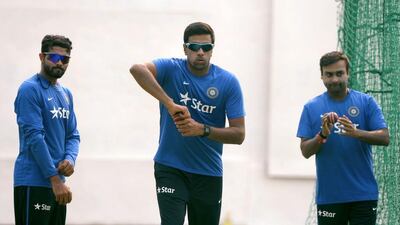 Ravichandran Ashwin, centre, has been backed by India captain MS Dhoni following a sub-par series against Australia. Prakash Singh / AFP