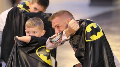 People don capes to take part in setting the Guinness World Record for "largest gathering of people wearing capes" for Batman’s 80th anniversary held at Warner Bros in Abu Dhabi. Pawan Singh / The National
