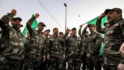 Members of Iraq's Popular Mobilisation Forces paramilitaries chant slogans ahead of the funeral of members of the group killed in a US strike in Baghdad in January. AFP