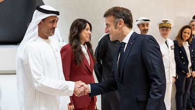 Mr Macron is greeted by Mohamed Al Mazrouei, Minister of State for Defence Affairs, at the Zayed National Museum