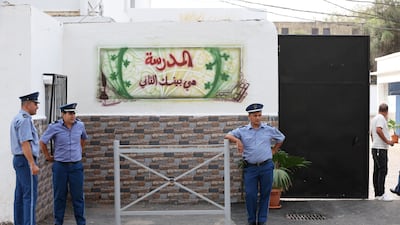 Police officers on guard outside a polling station in Algiers. EPA
