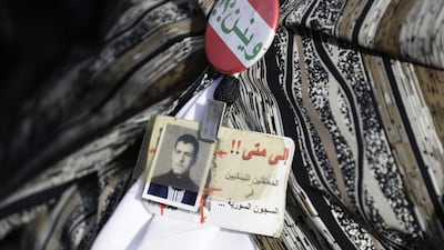 Families of Lebanese citizens who have disappeared since the Lebanese civil war in 1975, carry their pictures during a press conference in Beirut, Lebanon. AFP