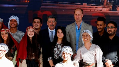 Britain's Prince William poses for a group picture with the mayor of Ramallah Musa Hadid and Palestinian children during a reception at the municipality in the West Bank city. Abbas Momani / AFP