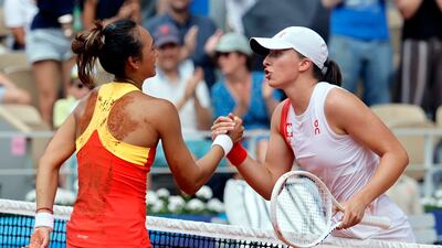 Qinwen Zheng shakes hands with Iga Swiatek after winning their semi-final. EPA
