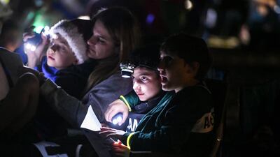 Abu Dhabi, United Arab Emirates - Young children participate in singing Christmas carols by candlelight in the desert. Khushnum Bhandari for The National