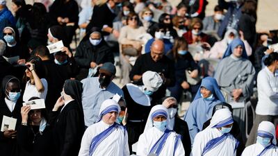 People attend a baptism by the Jordan River, near Jericho.