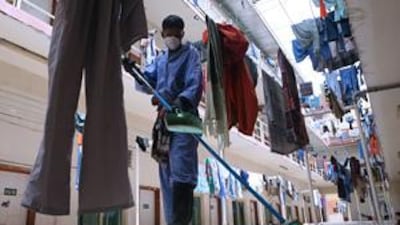 A worker sweeps the floor of one of the Arabtec labour camps in Jebel Ali.