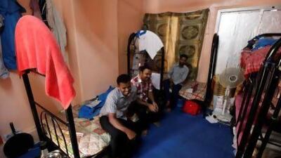 From left, Ramesh Thangiah, Sajjath Saifu, and Kameswaran Arumugam at their bachelor accommodation in Abu Dhabi. Satish Kumar / The National