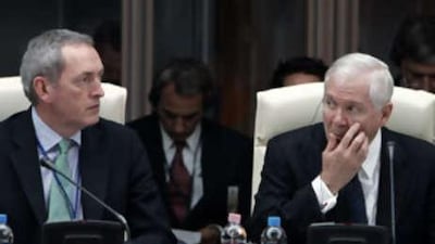 The US defence secretary Robert Gates, right, and British counterpart John Hutton listen during a round table meeting of Nato defense ministers in Budapest.
