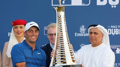 Italy's Francesco Molinari receives the Race to Dubai trophy from Mattar Al Tayer, Director General of the Roads and Transport Authority in Dubai, United Arab Emirates. AP Photo