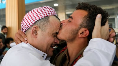 A former prisoner released by Saudi Arabia embraces a relative at Sanaa Airport after arriving on April 17. Reuters