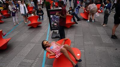 A child spins on chair in Times Square, New York City. Carlo Allegri / Reuters