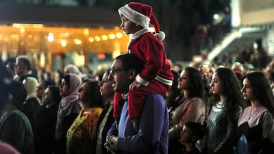Palestinians attend a Christmas tree lighting celebration on Tuesday, December 3, 2019, in Gaza City. AFP