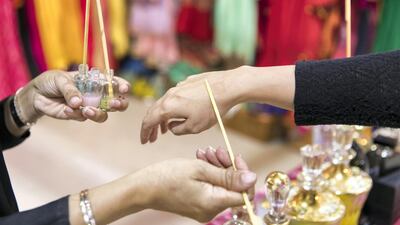 Mariam, 27, shows off her homemade perfumes. Reem Mohammed / The National