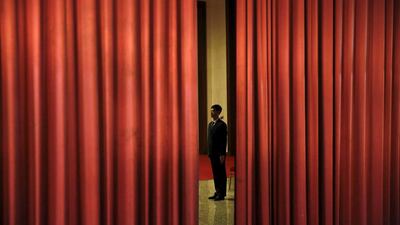 A Chinese security agent guards the area behind curtains inside the Great Hall of the People where sessions of the National People’s Congress (NPC) are taking place, in Beijing. Damir Sagolj / Reuters