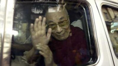 The Dalai Lama waves as he leaves hospital, where he has been undergoing tests for abdominal discomfort.