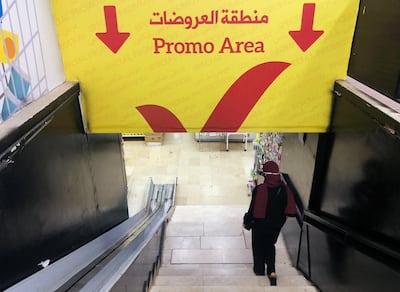 A woman walks down the stairs to a promotional area inside a supermarket in Beirut. Reuters