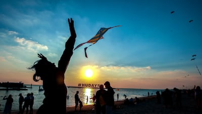 The sun sets during the last day of the Hudayriyat International Kite Festival in Abu Dhabi. Victor Besa / The National