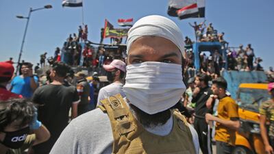 An Iraqi protester wears a face mask during an anti-government demonstration in the capital Baghdad. AFP