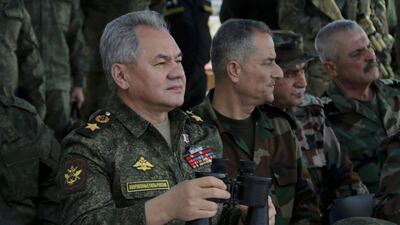 Russia's Defence Minister Sergey Shoigu, left, inspects Russian Navy drills in the Mediterranean Sea near Syria, on February 15. EPA